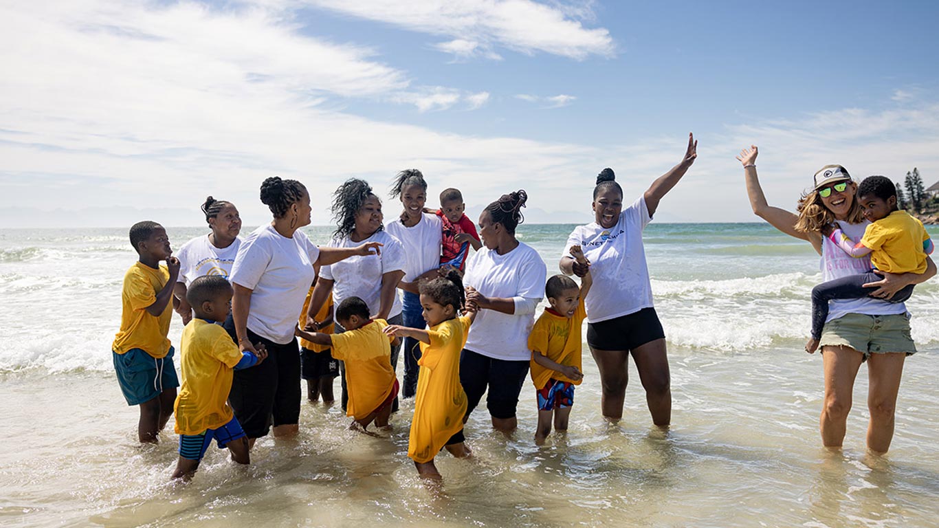 Michelle, carers and kids Michelle, carers, and the kids posing for a photo in the water.